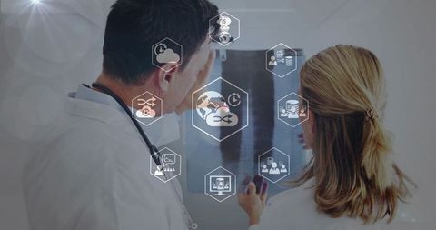 Doctors reviewing digital x-ray with telemedicine, cloud data and healthcare collaboration