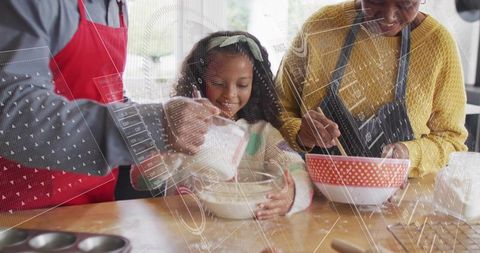 Multigenerational family baking together: child stirring bowl while adult pours and guides