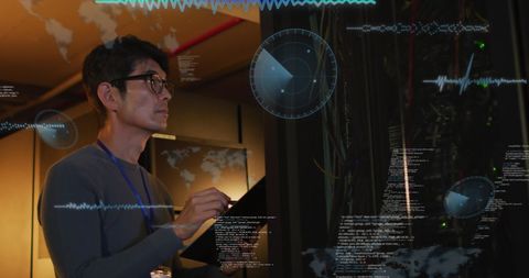 Asian engineer analyzing data in advanced server room