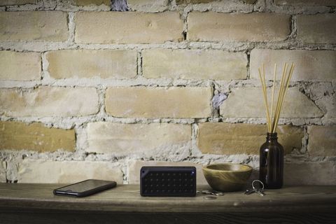 Rustic wooden shelf featuring portable bluetooth speaker smartphone reed diffuser wooden bowl keys