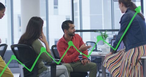 Diverse Coworkers Collaborating in Modern Office with Graph Overlay - Download Free Stock Images Pikwizard.com