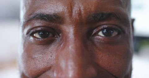 Mature man facing camera making direct eye contact showing skin texture and emotion