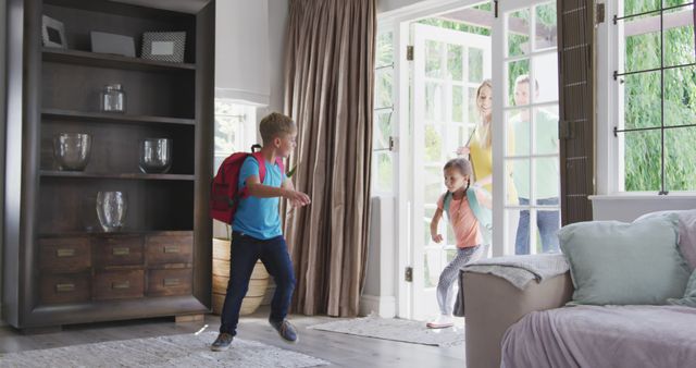Happy caucasian family wearing backpack and entering house together - Download Free Stock Photos Pikwizard.com