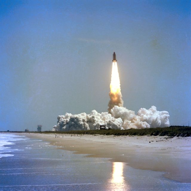 Space Shuttle Challenger ascends, creating a dramatic plume reflected in Cape Canaveral's Atlantic waters, April 1983. Ideal for historical documents, space exploration themes, educational resources, and NASA archives.