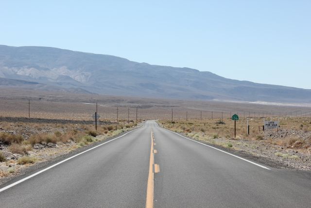 Empty Desert Highway Stretching into Distant Mountains - Download Free Stock Photos Pikwizard.com