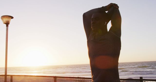 Athlete Stretching by the Ocean at Sunset - Download Free Stock Images Pikwizard.com