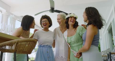 Joyful Female Friends Celebrating at Indoor Pre-Wedding Gathering