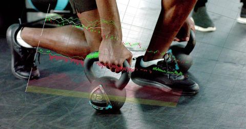 Gripping kettlebell performing squat with financial chart overlay on gym floor