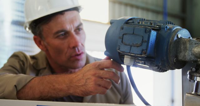 Engineer Inspecting Machinery in Industrial Setting - Download Free Stock Images Pikwizard.com