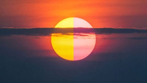 Split-color sun at sunset with horizontal cloud band and vibrant gradient sky