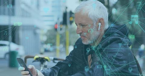 Senior man using smartphone with digital network overlay