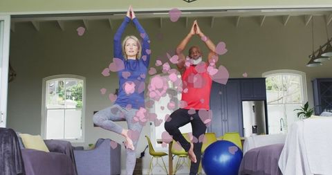 Senior diverse couple engaging in at-home yoga together