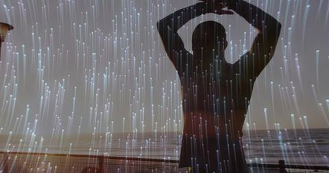 Silhouette Stretching on Ocean Boardwalk at Dusk with Digital Light Streaks for Wellness