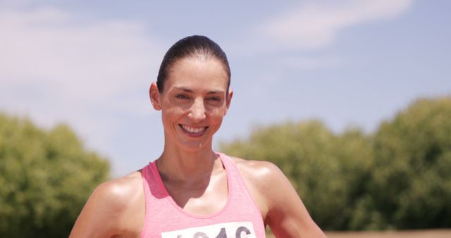 Smiling Female Runner in Race Bib Relaxing After Successful Marathon - Download Free Stock Images Pikwizard.com