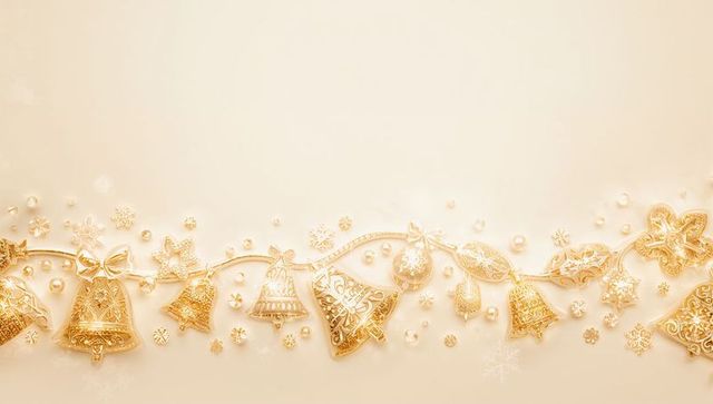 Shimmering Golden Christmas Garland with Ornate Bells and Pearls on Cream Backdrop