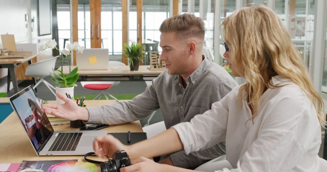 Creative professionals collaborating on laptop in modern office - Download Free Stock Images Pikwizard.com