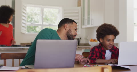 Father and Son Using Laptops at Home During Quarantine