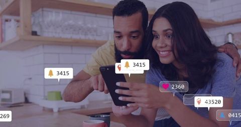 Couple Engaging with Social Media in Modern Kitchen Setting