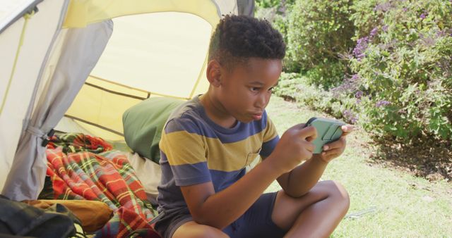 Young Boy Playing Mobile Game Outside Camping Tent - Download Free Stock Images Pikwizard.com