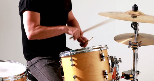 Drummer playing his drum kit in the studio - Download Free Stock Photos Pikwizard.com
