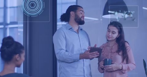 Colleagues Discussing Digital Technology Innovations in Modern Office