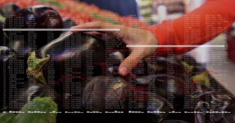 Hand picking fresh eggplant with grocery price overlay