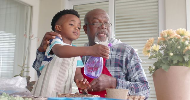 Grandfather and Child Watering Plants Together - Download Free Stock Images Pikwizard.com