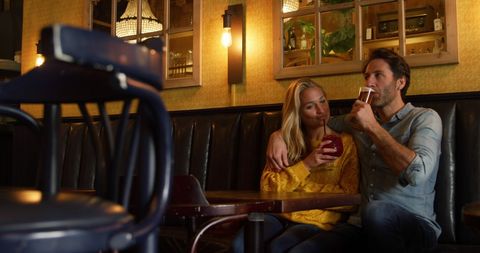 Couple Enjoying Drinks in Cozy Hotel Bar Setting - Download Free Stock Images Pikwizard.com