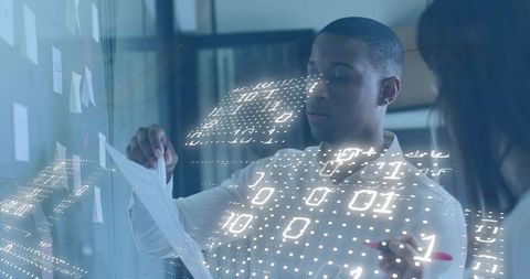 Team collaborating at glass wall with digital binary hologram and sticky notes for planning