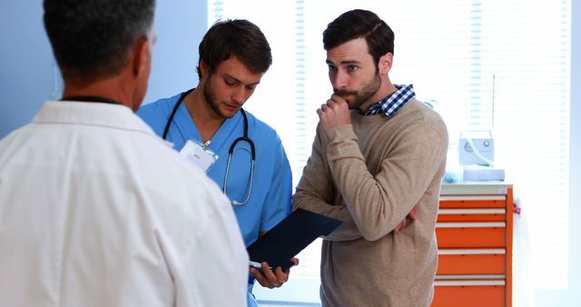 Two Doctors and Concerned Patient Discussing Test Results - Download Free Stock Images Pikwizard.com