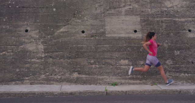 Female Athlete Running by Concrete Wall for Outdoor Workout - Download Free Stock Images Pikwizard.com