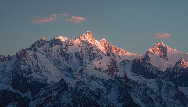 Serene alpine peaks bathed in sunrise glow