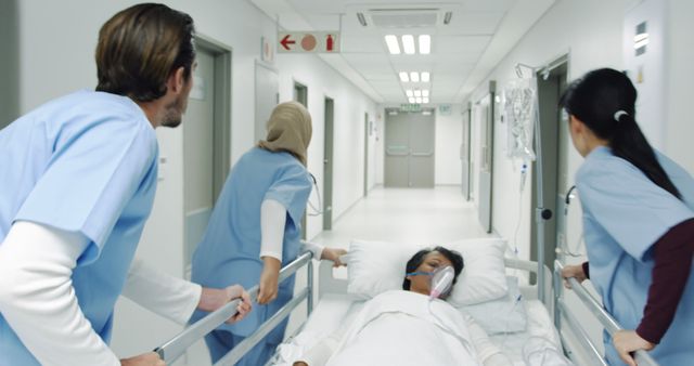 Medical team rushing a patient through a hospital corridor. The urgency suggests a critical situation in a healthcare setting.