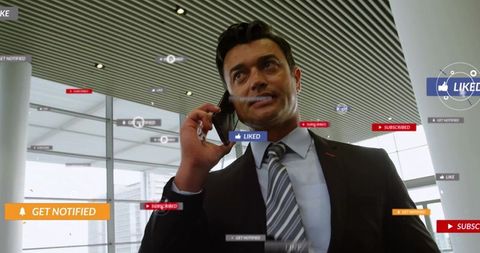 Businessman on phone engaging with social media notifications in modern office
