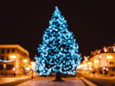 Blurry illuminated christmas tree with festive lights