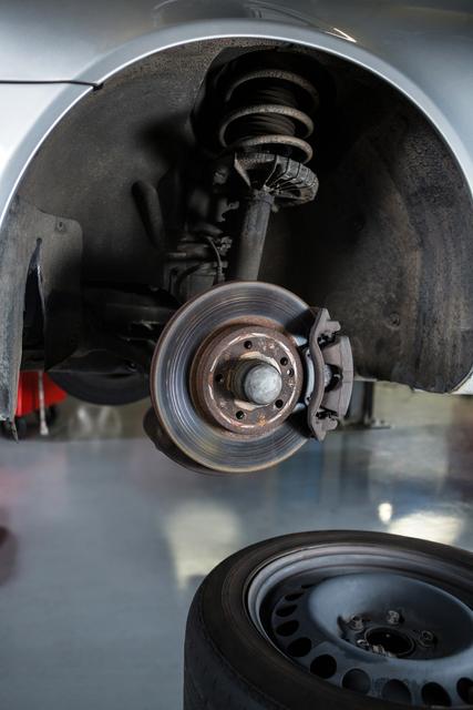 Close-up of car tyre and break disc at repair garage