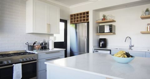 Modern Kitchen Interior with Stainless Steel Appliances and White Cabinetry - Download Free Stock Images Pikwizard.com