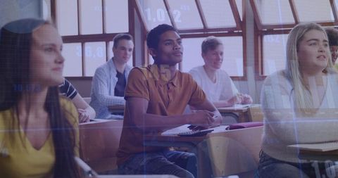 Attentive students listening and taking notes in sunlit classroom with data overlay