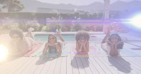 Group of Women Enjoying Sunny Day by Poolside Deck