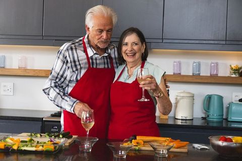 Senior Couple Prepping Vegetables Together in Modern Kitchen