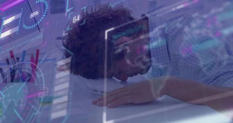 Burned-out knowledge worker collapsing on laptop at workstation with data hud overlays