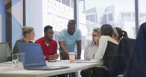 Team Collaboration During Focused Business Meeting in Modern Office