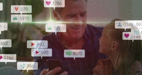 Grandfather and Granddaughter Enjoying Family Time with Technology