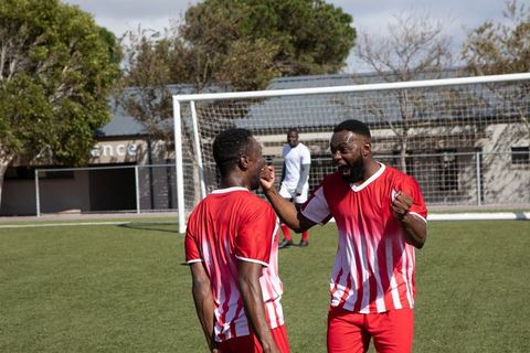 Celebrating Victory: Young Athletes in Energized Team Spirit on Soccer Field
