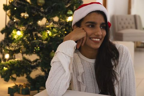 Festive Holiday Scene with Woman by Christmas Tree