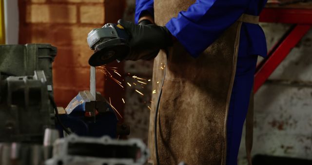 Factory Worker Using Angle Grinder On Metal Bar Generating Sparks - Download Free Stock Images Pikwizard.com