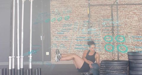 Female athlete performing medicine ball core workout in gym with HUD data overlay