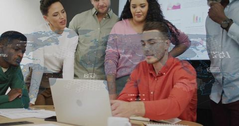 Dynamic Team Analyzing Data on Laptop During Business Meeting