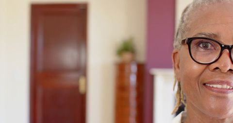 African american senior woman smiling wearing glasses and blouse collar home portrait