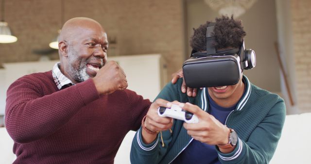 Senior Man and Young Adult Enjoying Virtual Reality Game - Download Free Stock Images Pikwizard.com